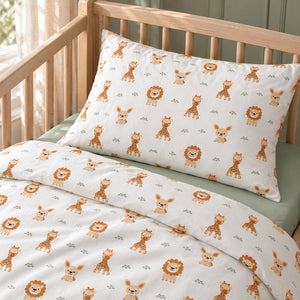 Close-up of the safari animal pillowcase and matching duvet cover, showing beige lions, brown giraffes and a plain sage green fitted sheet.