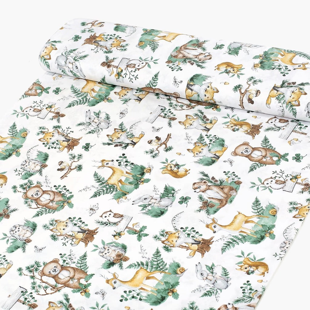 Sage green woodland animal cotton fabric on a roll from Fabricco UK, 160 cm wide, showing the horizontal fox and deer print.