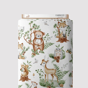 Sage green woodland animals cotton fabric by the metre from Fabricco UK with foxes, deer, bears and leaves for nursery sewing.