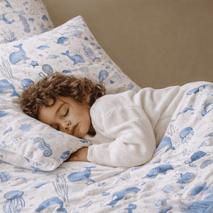 Sea life cot and toddler bedding set in baby boy ocean-themed nursery bedroom