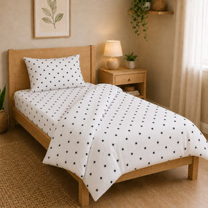 Monochrome single duvet cover set with black stars on white cotton bedding in a natural UK bedroom