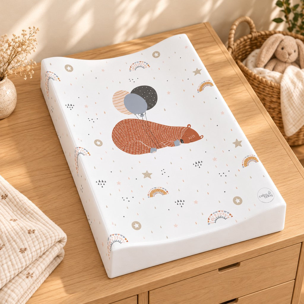 Full view of the sleeping bear and balloons baby changing mat showing its curved raised sides and scattered rainbow and star pattern