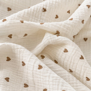 Soft crinkled muslin double gauze texture on a little brown hearts baby sheet, breathable cotton bedding for newborns, babies and toddlers.
