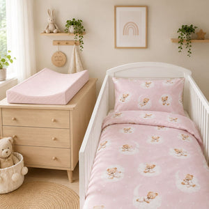 Soft pink anti-roll baby changing mat with matching teddy bear bedding in a Scandinavian baby girl nursery Fabricco UK