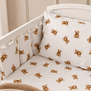 Close-up of brown teddy bear cot bedding with individual padded cot wraps showing the white cotton teddy bear print