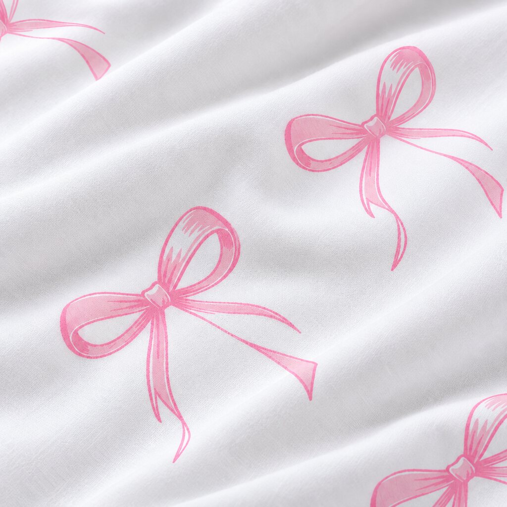 Close-up of white 100% cotton fabric with hand-drawn pink ribbon bows and a soft plain weave