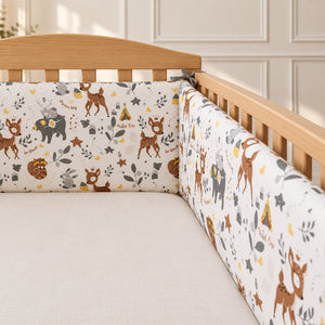 Close-up of woodland animals padded cot bumper with grey ties and three-panel construction for a UK 60 × 120 cm cot.