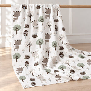 cotton fabric draped over an oak rail, showing a vertical woodland print of beige deer, brown hedgehogs and trees