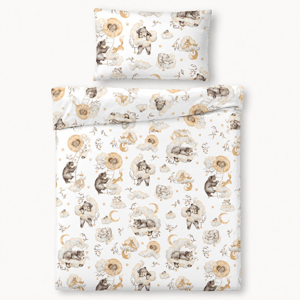 Close-up of Woodland Dreams baby bedding with woodland animals, cream clouds, golden moons and stars on soft 100% cotton.