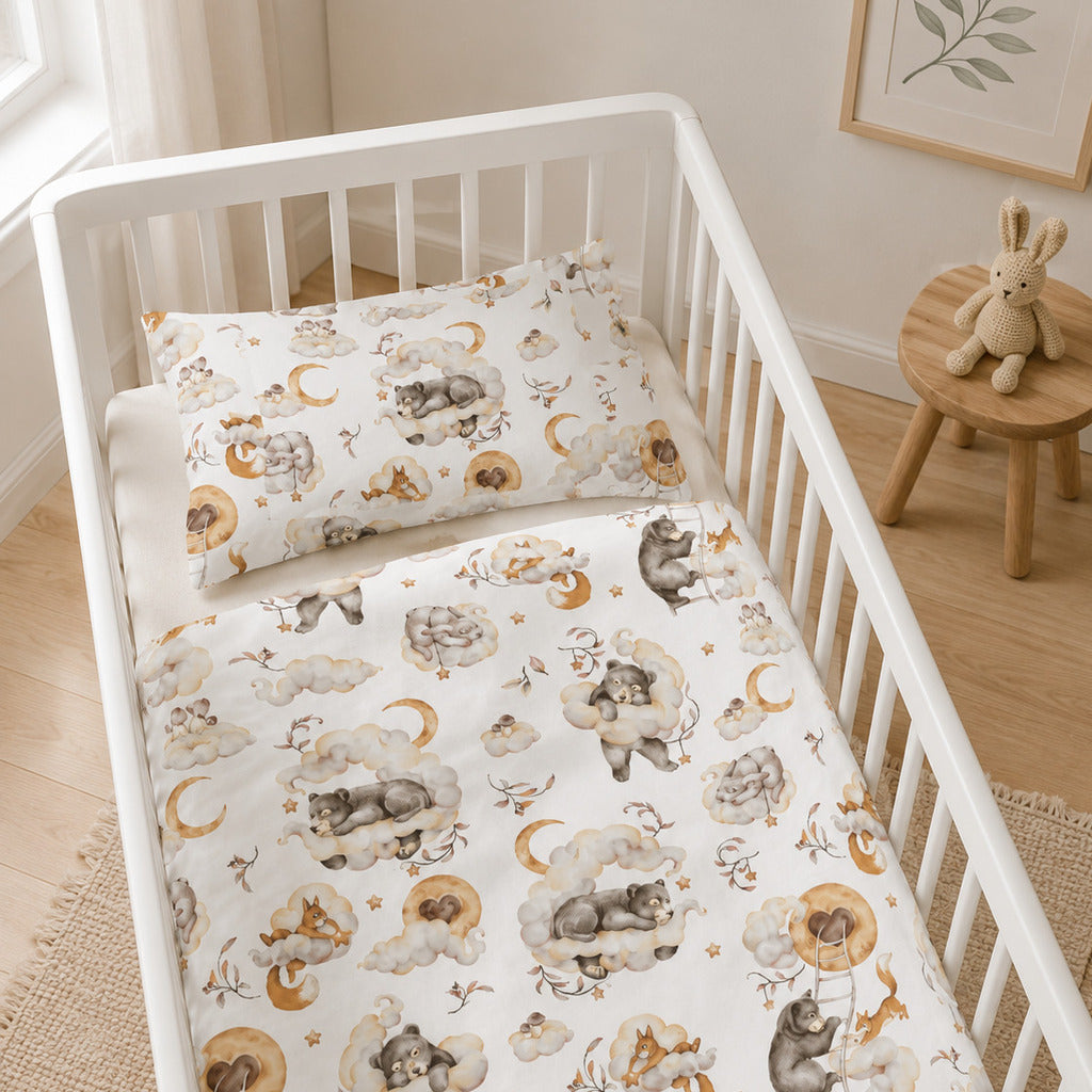 Woodland Dreams cot and cot bed bedding set with sleepy woodland animals, clouds and moons in a neutral beige nursery.
