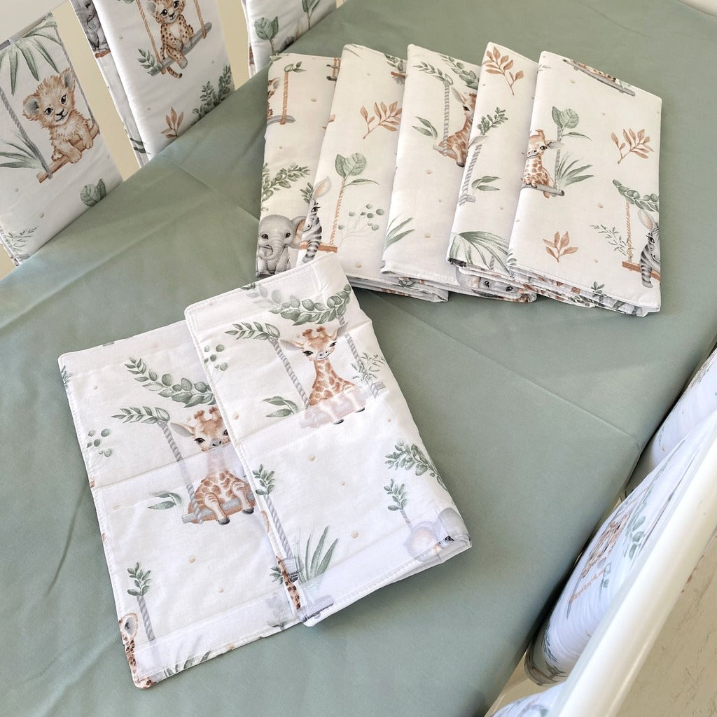  Sage green cot bed wraps with jungle animal prints, made from soft cotton with adjustable Velcro fastenings for a secure and breathable fit.

