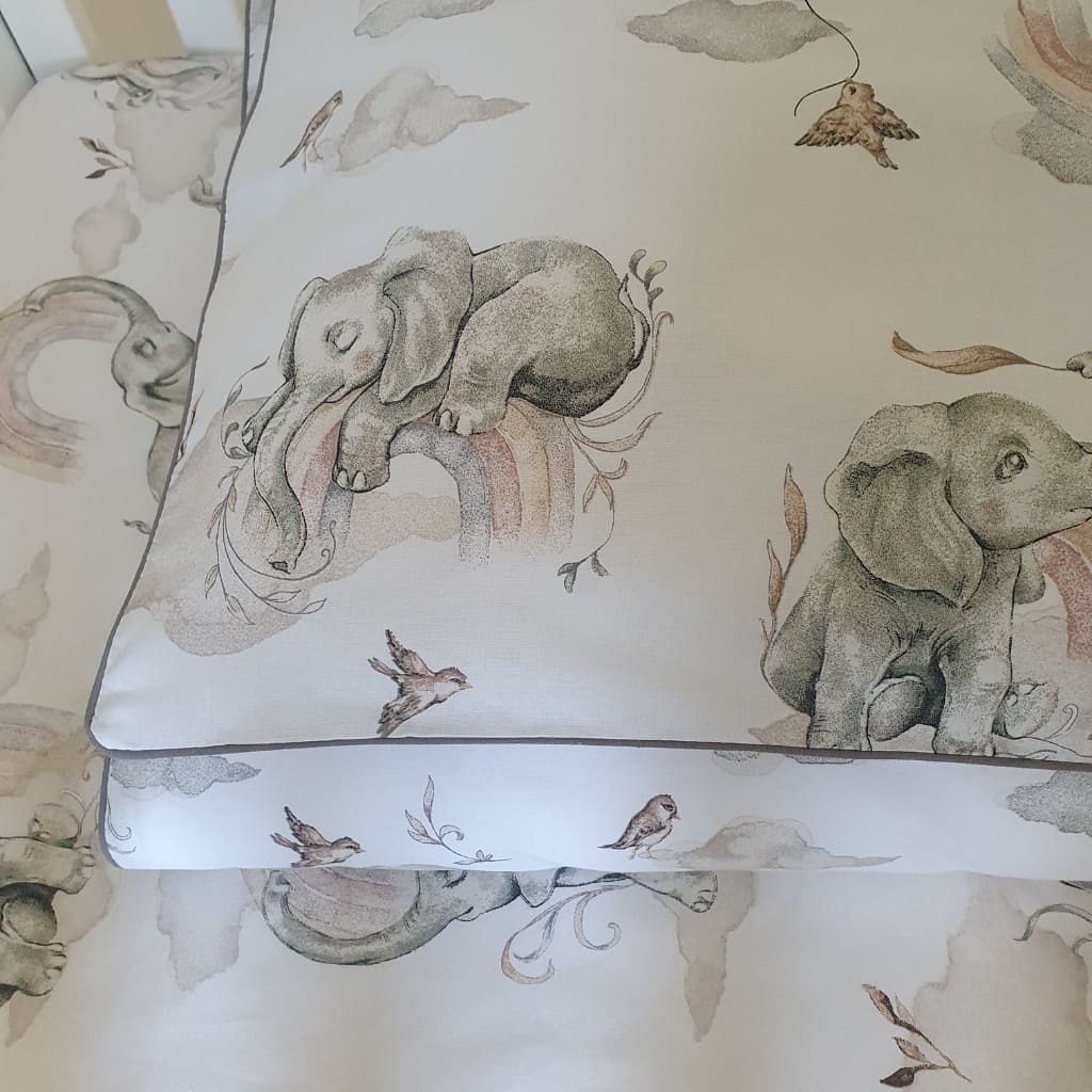 natural nursry, baby room decor, Soft_and_cozy_baby_bedding_set_featuring_playful_elephants_and_colorful_rainbows_in_gentle_natural_tones_perfect_for_a_nursery