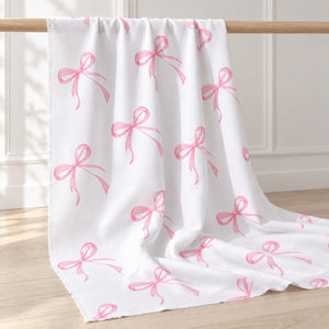 Pink bow 100% cotton fabric by the metre displayed in a light Scandinavian sewing studio, Fabricco Uk, Fabric Shop Ireland