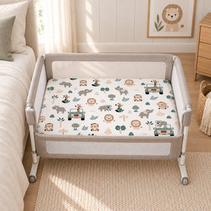 Safari Adventure cotton fitted sheet on a Next2Me bedside crib mattress, with jungle animals and sage green safari jeeps.