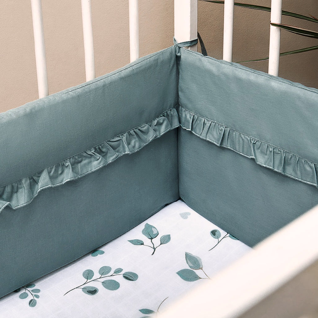 sage green cot bumper made from 100% cotton with decorative ruffle trim, soft padded baby cot bumper designed for 120x60 cm cots.